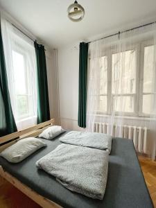 a bedroom with a bed with two pillows on it at Nice View Rooms In Old Town in Krakow