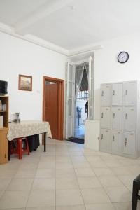 a kitchen with a table and cabinets and a hallway at Affitta camere Mimi family in Florence