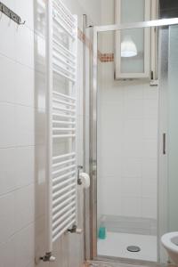 a bathroom with a shower with a glass door at Affitta camere Mimi family in Florence