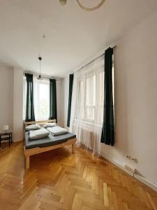 a bedroom with a bed in the corner of a room at Nice View Rooms In Old Town in Kraków