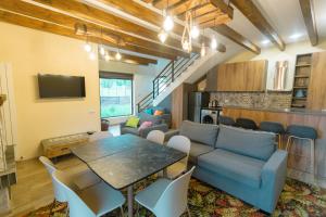 a living room with a blue couch and a table at Khata's cozy place in Bakuriani