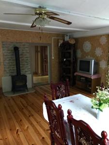 a living room with a table and a fireplace at Wiejski Domek na Roztoczu 