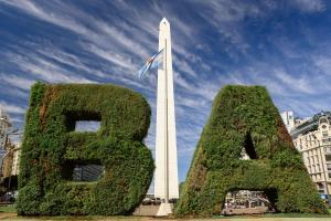 a monument with two plants in front of a tower at Top Rentals Downtown in Buenos Aires