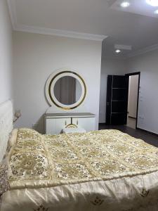 a bedroom with a large bed and a mirror at Modern Apartment 3 room in Sheikh Zayed N5 الشيخ زايد in 6th Of October