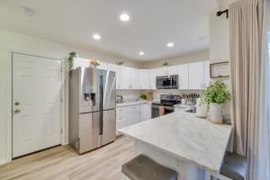 a kitchen with white cabinets and a stainless steel refrigerator at Chic Penn Estates Home 7 Mi to Camelback Mountain in East Stroudsburg