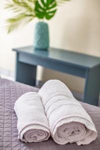 a couple of towels are laying on a bed at Sofia's Hotel in Kalamaki