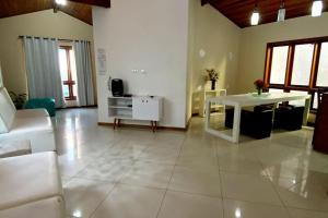 a living room with a white table and a white couch at OPEN HOUSE VARGAS in São Paulo