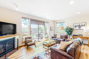 a living room with a couch and a fireplace at WinterStar E-2 in Fraser