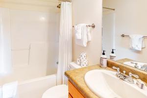 a bathroom with a sink and a toilet and a tub at WinterStar E-2 in Fraser +43 photos
