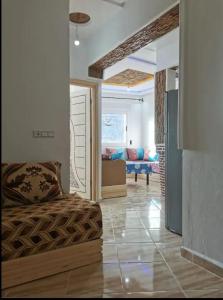 a living room with a couch and a living room with a couch at Appartement aboubakr ahayek in Chefchaouen