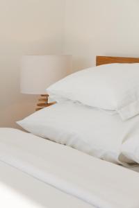 two white pillows on a bed in a room at Apartment Slavia District in Belgrade