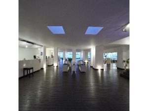 a lobby with white chairs and windows in a building at EN Resort Kumejima EEF Beach Hotel - Vacation STAY 59139v in Kumejima