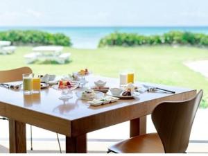 a table with plates of food sitting on top of it at EN Resort Kumejima EEF Beach Hotel - Vacation STAY 59139v in Kumejima