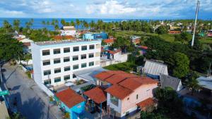 an aerial view of a town with a white building at Pousada Sal e Mar Maracaipe in Porto De Galinhas