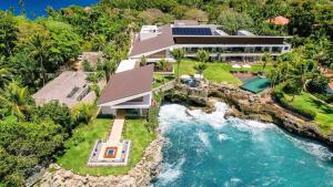 an aerial view of a house with a waterfall at Sunny Vacation Villa no 1 in Bonao