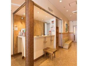 a lobby of a hospital with a bench and a counter at Hotel Axia Inn Kushiro - Vacation STAY 67240v in Irifunechō