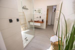 a bathroom with a sink and a mirror at Penthouse-Wohnung I 100 qm I Blick auf die Weinreben I Nespresso I EMMA Matratzen in Auggen +30 photos