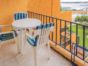 a white table and two chairs on a balcony at Live el Poris chinchorro in Poris de Abona