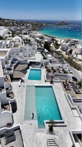 an aerial view of a resort with a swimming pool at The George Hotel Mykonos in Platis Gialos