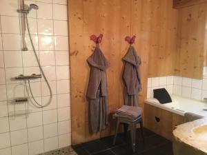 a bathroom with two towels hanging on a wall at La Chabraque in Le Barboux +16 photos