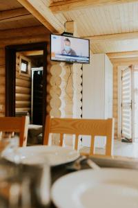 a flat screen tv on the wall of a room at Айворі Хаус in Mykulychyn