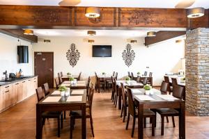 a dining room with wooden tables and chairs at Willa Szafran in Dzianisz +32 photos