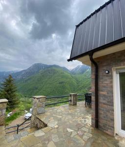 a stone patio with a view of mountains at Villat Twin’s in Peje