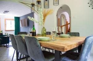 a dining room with a wooden table and chairs at Wellness mitten in der Wasserfallstadt Triberg in Triberg