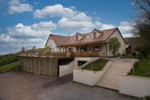 a house with a large deck on the side of it at Domaine des Rigaud in Garchizy