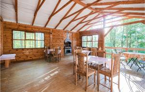 a room with tables and chairs in a log cabin at 1 Bedroom Stunning Home In Suleczyno in Sulęczyno