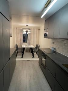 a kitchen with a table and chairs in a room at Central Apartment with 3 bedrooms in Norrköping