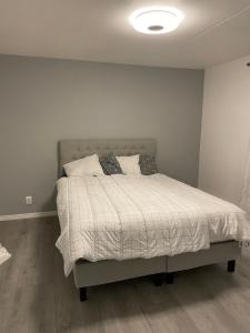 a bedroom with a bed with white sheets and pillows at Central Apartment with 3 bedrooms in Norrköping