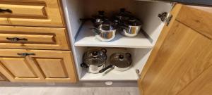 a cupboard with pots and pans sitting inside of it at Inviting 1-Bed Apartment in Coventry in Coventry