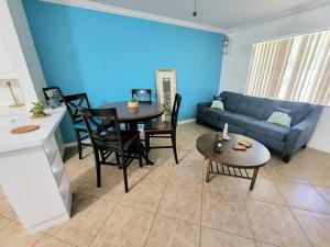 a living room with a couch and a table at Stylish 2BR Villa full kitchen 10 mins from Beach in Fort Lauderdale