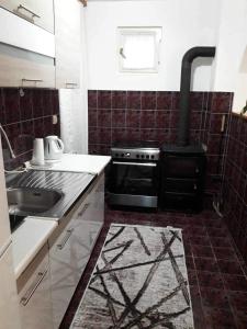 a kitchen with a stove and a sink at Apartman u Kuci u Konjicu in Konjic