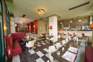 a restaurant with tables and chairs and a bar at Delphi Art Hotel by Prima Hotels in Athens