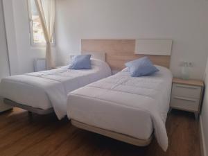 Postel nebo postele na pokoji v ubytování Maile Apartamentos