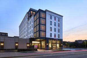 a tall building on a city street at dusk at Moxy Charleston Downtown in Charleston