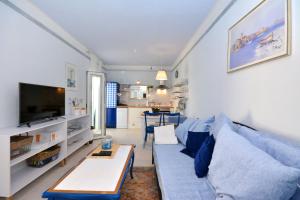 a living room with a blue couch and a table at Apartment Pepica in Postira