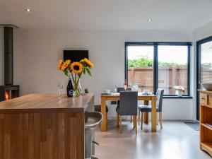 a kitchen and dining room with a table and chairs at Cedar Cottage in Aboyne