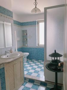 a blue and white bathroom with a sink and a toilet at Stars Home in Tropea +68 photos