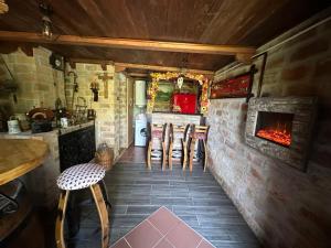 a kitchen with chairs and a fireplace in a room at Forest paradise in Koprivnica