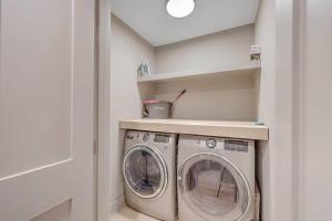 a laundry room with a washer and dryer at New Listing! Seagrove Villa 3A - Luxurious Ocean View! in Isle of Palms