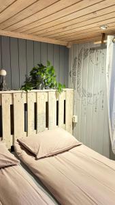 a bed with a wooden headboard in a bedroom at “ Mandala” place for 2 in Sauda