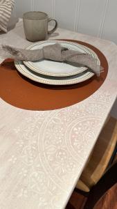 a table with a plate and a napkin on a table at “ Mandala” place for 2 in Sauda