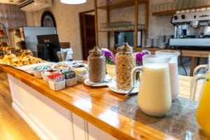 a counter with some food and a bottle of milk at O2 Hotel Valeria del Mar in Valeria del Mar