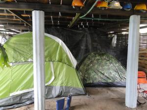 two green tents are sitting in a garage at Finca Ecoturística Tierra Blanca in La Laja