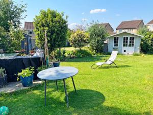 a table and a chair in a yard at Self contained annex with full kitchen in Witney