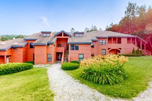 a large house with a grass yard in front of it at Trail Creek 33 in Killington