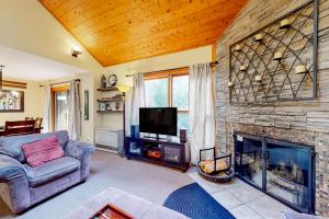 a living room with a couch and a fireplace at Trail Creek 33 in Killington